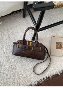 Macro shot of dark brown vintage handbag texture with gold buckle detail on faux fur