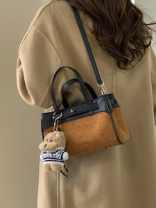 Elegante borsa a mano in pelle scamosciata marrone e pelle nera con ciondolo a orso