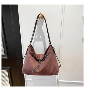 Detail of dark brown vintage hobo bag showing matte suede texture and leather strap