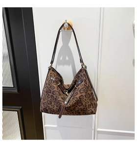 Detail of hobo leopard print tote bag with brown straps and adjustable buckle detail