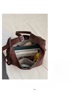 Interior view showing the large capacity and storage pockets of this brown tote bag