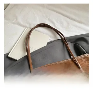 Detail shot of leopard print tote bag texture and logo handle on white bedding background