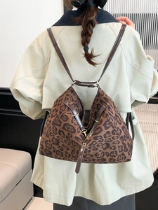 Chic leopard print convertible backpack tote bag with leather straps on a model