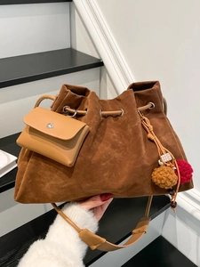 Brown vintage suede oversized bucket bag with pleated texture and colorful charm