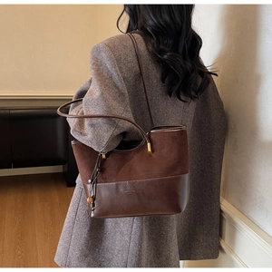 Detail view of coffee brown contrast tote bag featuring fashion print and drawstring tassels