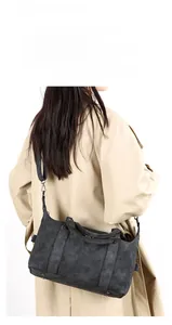 Retro grey large tote bag with vertical stitching shown cross-body on a beige coat