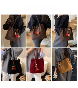 Collage of large suede tote bags in various colors featuring decorative pom pom charms