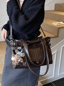 Minimalist deep brown tote bag with metal buckles and cute plush bear charm