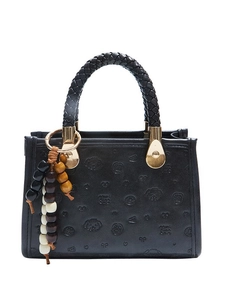 Elegant black embossed crossbody bag with leather woven handle and colorful beaded tassel