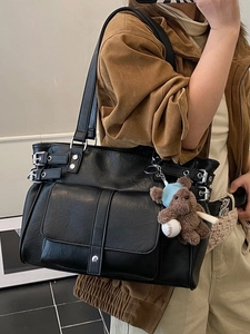 Minimalist black faux leather tote bag with silver buckles and a cute plush bear pendant