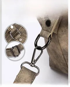 Detailed close-up of gunmetal hardware and textured brown leather on a vintage tote bag