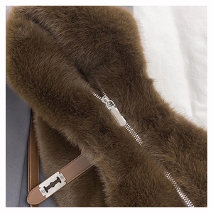 Close-up of fluffy brown faux fur texture and silver metal zipper on a plush tote bag