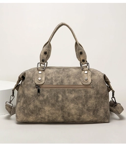 Rear view of vintage tote bag showing textured leather finish and functional zip pocket