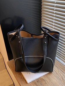 Minimalist black lychee leather bucket bag with silver zippers and large capacity