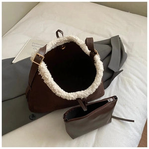 Detail view of brown suede bucket bag with sherpa trim and matching small pouch