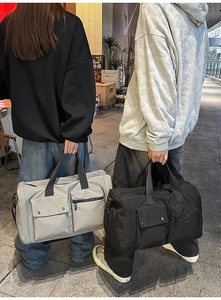 Dual travel bags in grey and black with waterproof nylon and functional pockets