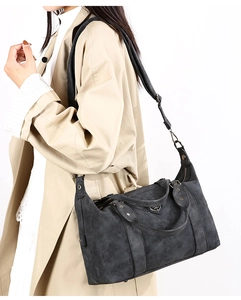 Dark gray vintage tote bag in matte synthetic leather styled with a beige trench coat