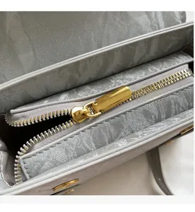 Close-up of premium smooth golden metal zipper on vintage crossbody bag detail