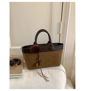 Detail of vintage leopard style shoulder bag with brown suede and leather stitching