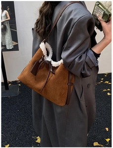 Brown faux suede hobo bag with white shearling trim and brown leather shoulder strap