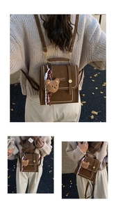 Detail of vintage brown leather backpack with white stitching and bear charm on back