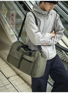 Army green large travel bag with multiple pockets and wide black shoulder straps