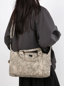 Retro distressed gray tote bag for women shown as a shoulder bag on a model