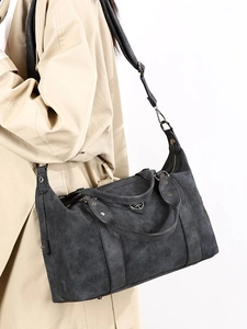 Deep gray frosted tote bag with metal shield logo and adjustable wide shoulder strap