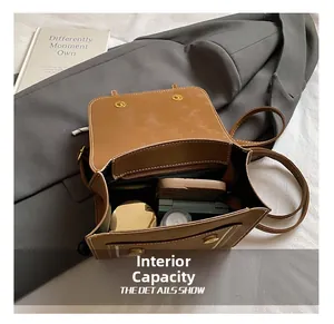 Detail view of the vintage brown backpack interior with pockets for phone and makeup