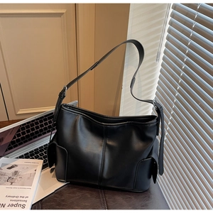 Detail of black leather hobo bag with side pockets and adjustable strap for work