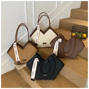 Detailed view of four tote bags in cream, brown, and black with unique V-shaped openings