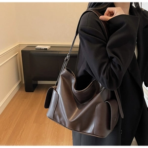 Close-up of deep brown soft PU leather shoulder bag with side pockets and large capacity
