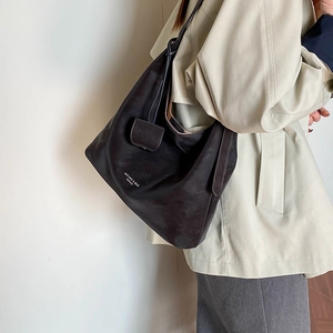 Close-up of black matte leather shoulder bag with white MUFANNI fashion lettering detail