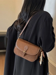 Retro brown frosted suede crossbody bag with vintage metal buckle and beaded charm for women
