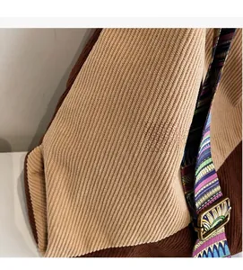 Close-up of corduroy patchwork fabric with ethnic geometric strap and metal buckle
