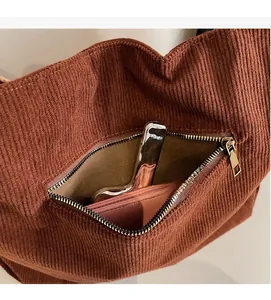 Detail shot of the brown corduroy tote bag showing its spacious inner zipper pocket