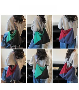 Detail of color-block canvas tote bag with ethnic style striped strap on model