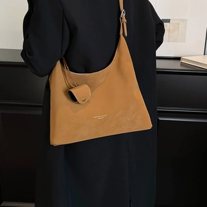 Caramel suede tote bag detail featuring a matching mini snap pouch and wide shoulder strap
