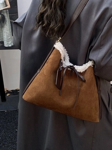 Brown suede underarm bag with white faux fur trim and bow detail for autumn winter