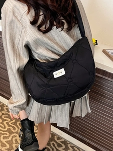 Fashionable black heart-quilted puffer crossbody bag with a spacious crescent design