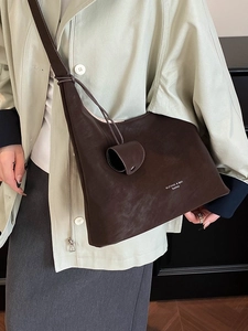 Deep brown oversized faux suede tote bag featuring a half-moon silhouette and logo detail