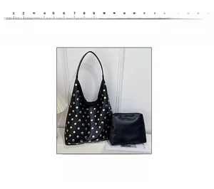 Detail view of black vintage rivet shoulder bag set with silver studs and small pouch