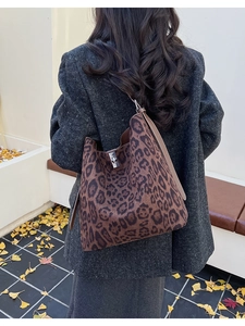 Detail of leopard print hobo bag with silver buckle and soft suede texture finish