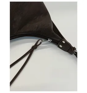 Detailed macro of dark brown leather texture with silver zipper and hardware