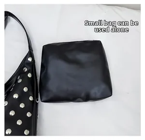 Detail of black faux leather tote with silver rivets and detachable inner zipper pouch