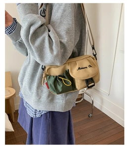 Detail view of American vintage crossbody bag with olive pocket worn by a model