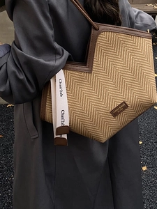 Minimalist herringbone woven tote bag with brown PU leather trim and side strap detail