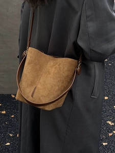 Brown matte suede bucket bag for women featuring deep brown leather straps and metal hardware
