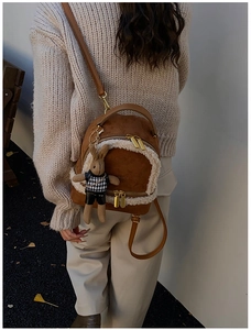 Brown faux suede backpack with white shearling trim and cute plush rabbit charm