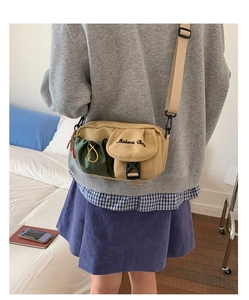 Close-up of khaki and olive green patchwork crossbody bag with Moborn Bag embroidery